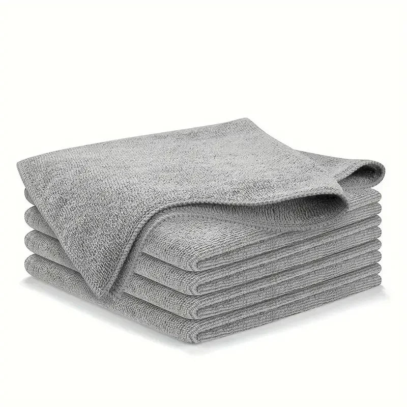 Stack of folded gray microfiber towels on white background