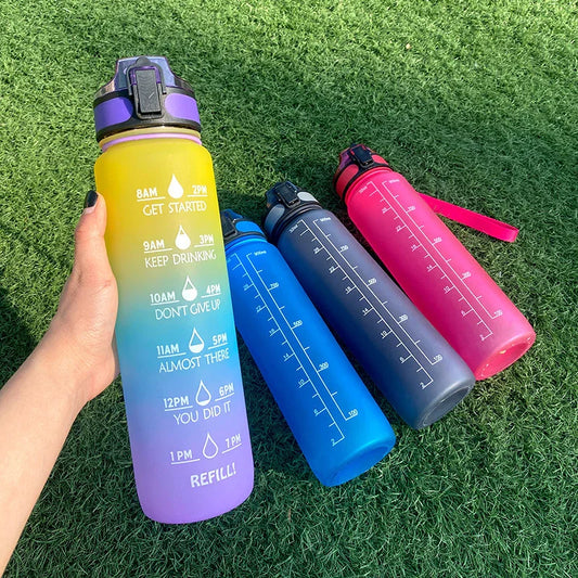 Colorful motivational water bottles with time markers on green grass, Absolute Level Up lifestyle