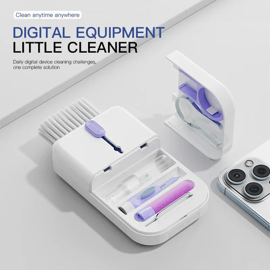 Compact digital device cleaning kit with brushes and tools beside a smartphone on a white surface
